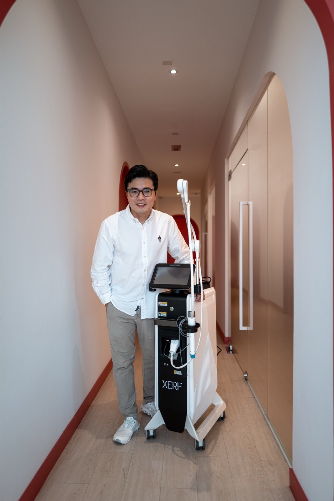 Dr Ong Jin Khang standing with the newly delivered XERF console in the corridor of The Retreat Clinic