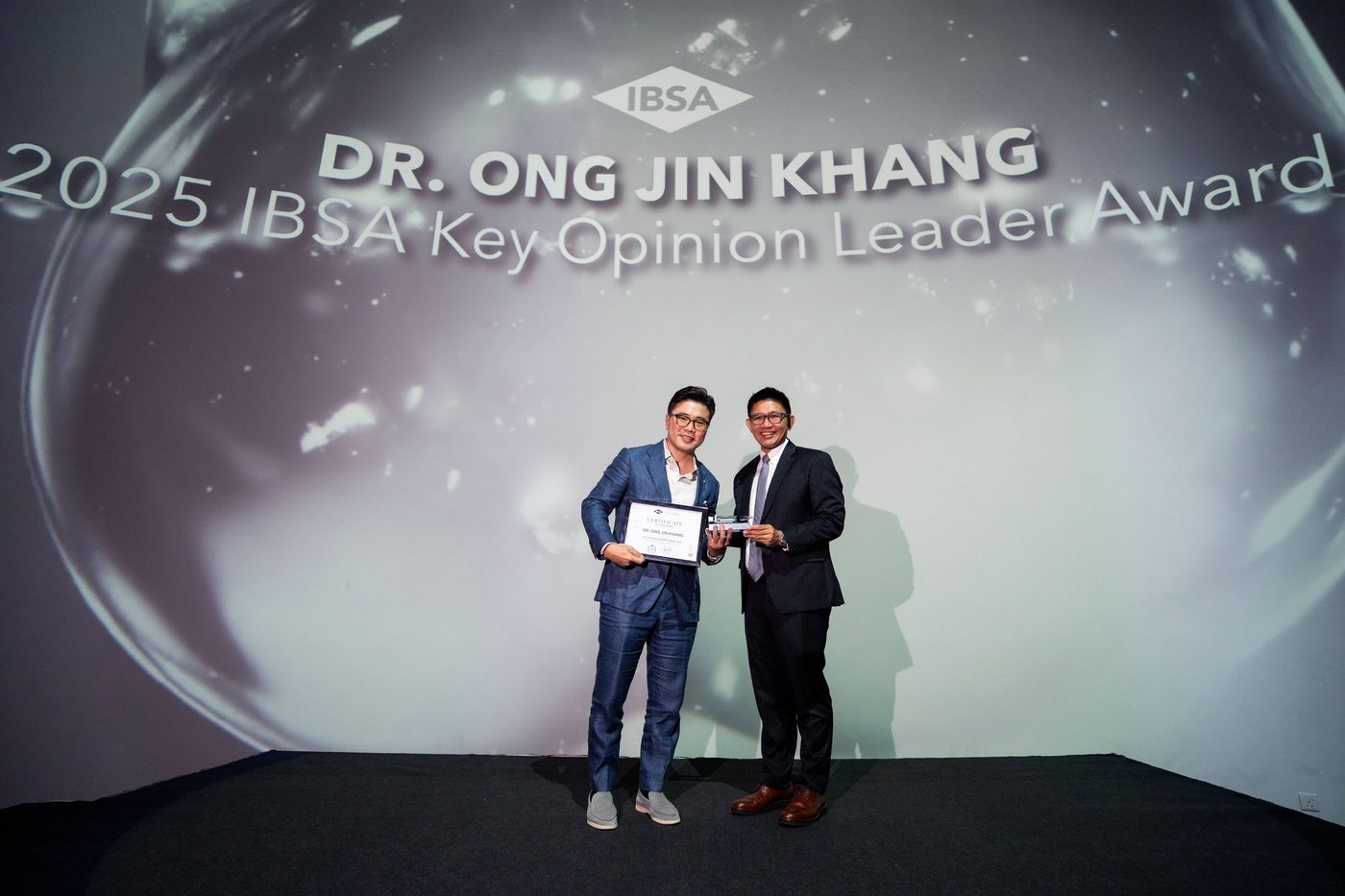 Dr Ong Jin Khang on stage at the NeoAsia Gala Awards Malaysia, September 2026, receiving the 2025 IBSA Key Opinion Leader Award
