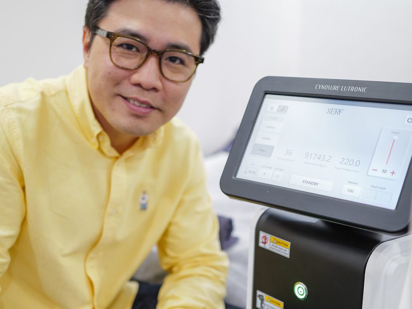 Dr Ong Jin Khang holding the XERF handpiece, a close documentary photograph showing the device in a clinical setting with no patient present