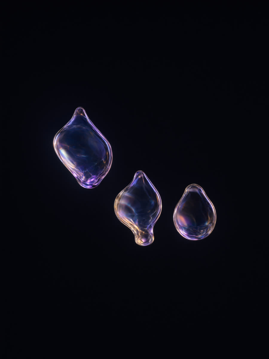 Three small separate translucent glass droplets